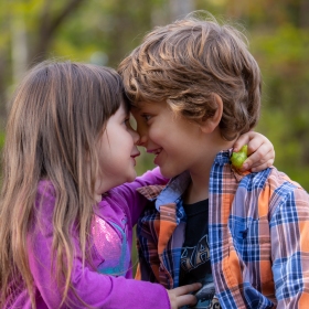 girl and boy pressing noses together in photograph